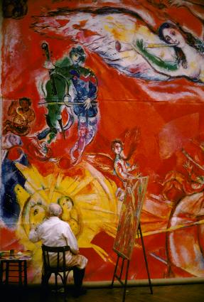 Chagall painting an immense mural, with mockup next to him.