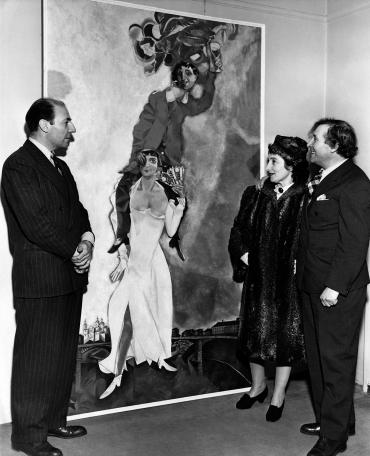Pierre Matisse, Marc and Bella Chagall on either side of the painting, more than 2 meters (6.5 feet) high: Double Portrait With a Glass of Wine.